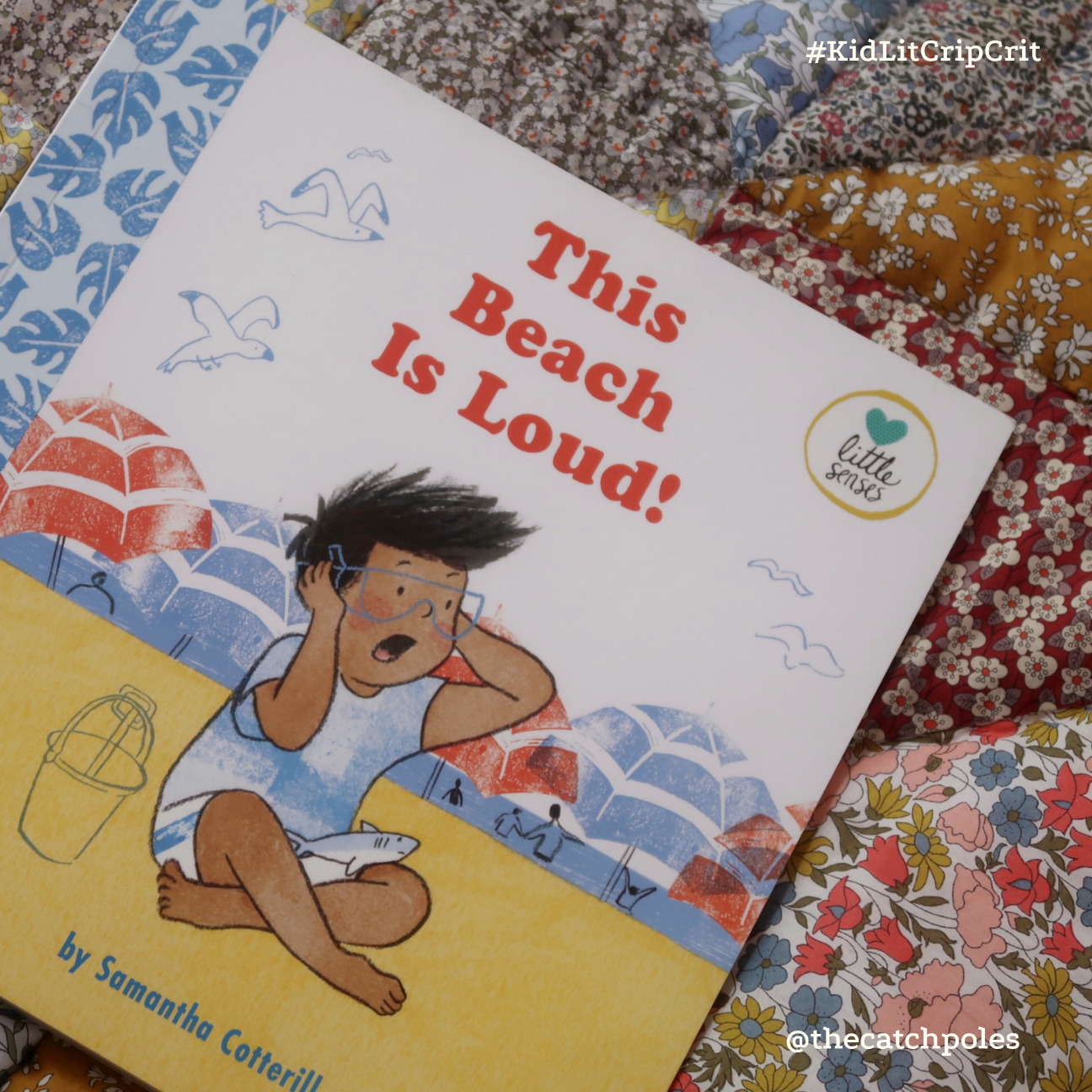 A book portrait of This Beach Is Loud -  a picture book with a child with brown skin and black hair on the front - on the beach, holding their ears.