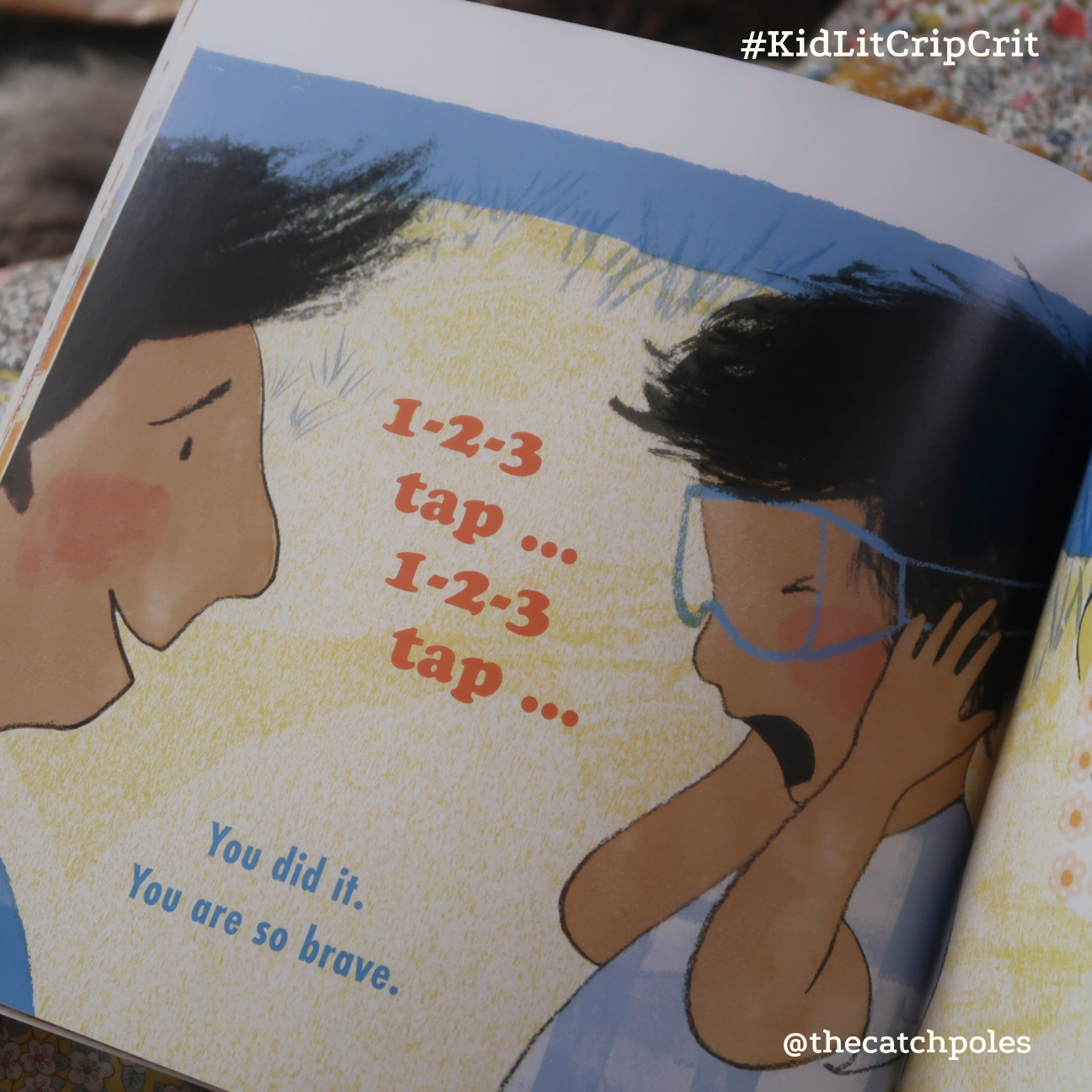 The child covers their ears, while the dad says '1-2-3 tap… You did it. You are so brave.'