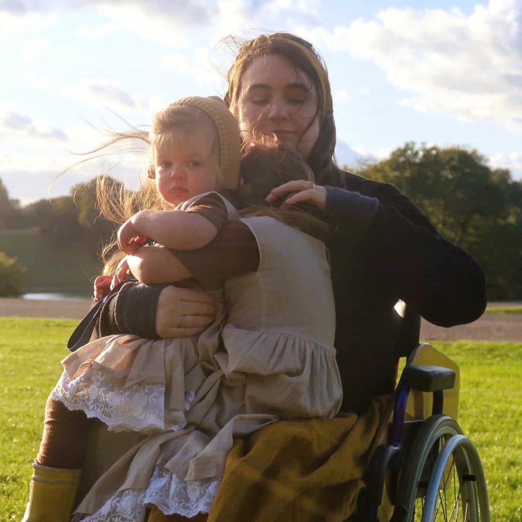 Lucy Catchpole with both her daughters on her lap.