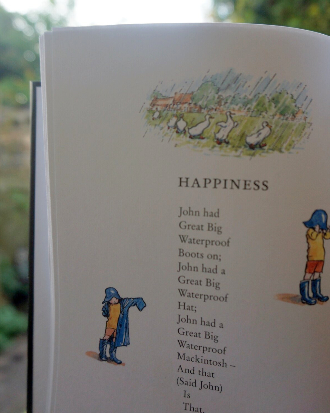 A page from When We Were Very Young - the poem Happiness is partially illustrated with original watercolour vignettes, of Christopher Robin in waterproofs. The poem is the same as the text on the right of the image.