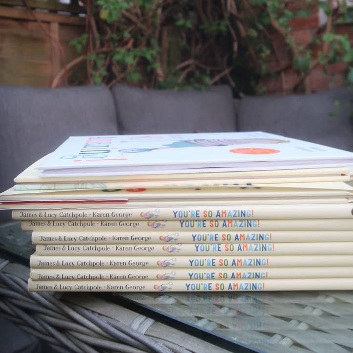 A stack of copies of books of You’re So Amazing in our garden