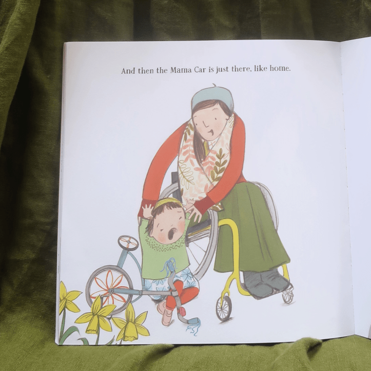 A page from Mama Car. Illustration shows the mother in her wheelchair, scooping up her young child - who's crying. The words on the page read: "And then the Mama Car is just there, like home."